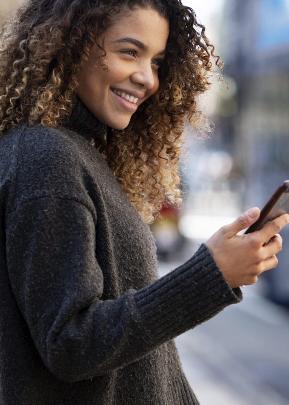 young-woman-using-her-smartphone-city